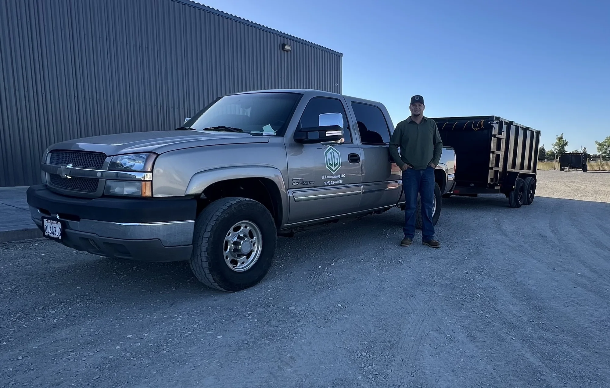 Jose Angel Loza Jr., owner of JL Landscaping LLC, beside the company truck